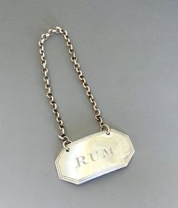 A SILVER RUM DECANTER LABEL BY FEMALE SILVERSMITH ELIZABETH MORLEY