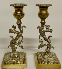 A PAIR OF REGENCY GILT BRONZE SCULPTURAL CANDLESTICKS C1820 EACH CAST AS A TREE WITH SQUIRRELS AMONGST THE BRANCHES CAMPANA SCONCES AND ON SQUARE BASES