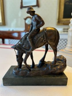 A CHARMING BRONZE FIGURE OF A YOUNG BOY ON A HORSE C1920