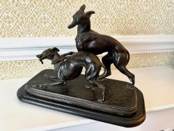 A SPELTER SCULPTURE OF TWO WHIPPETS C1920