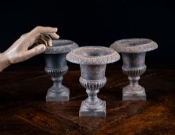 THREE MINIATURE CAST IRON URNS
