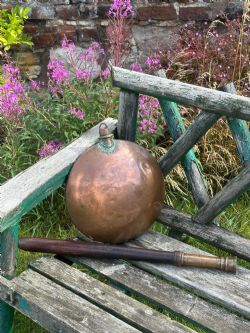 AN UNUSUAL GEORGIAN COPPER MOONSHAPED WARMING FLASK WITH DETACHABLE OAK HANDLE