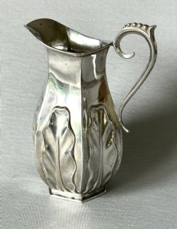 AN UNUSUAL LATE VICTORIAN SILVER CREAM JUG
