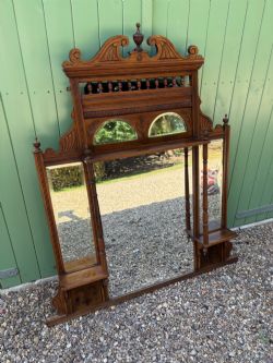 AN EDWARDIAN WALNUT OVER MANTLE MIRROR