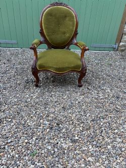A VICTORIAN OPEN ARMED MAHOGANY ARMCHAIR