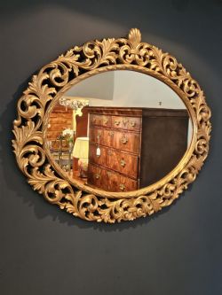 LARGE CARVED TIMBER GILT OVAL MIRROR
