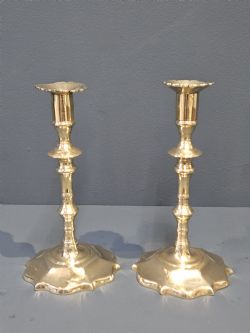 PAIR OF PRE 1750 GEORGE II BRASS PETAL BASE CANDLESTICKS