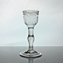 GEORGIAN SWAG AND TAIL ENGRAVED BALUSTROID STEM WINE GLASS